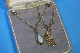 A 9ct gold opal set ring and a 9ct chain set with an opal and a pair of earrings