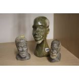 Three carved African heads