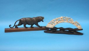 A carved horn tiger and piece of carved ivory