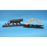 A carved horn tiger and piece of carved ivory