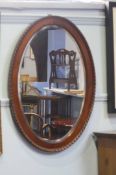 A Mahogany oval mirror 87 x 62cm