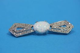 An 18ct white gold bow brooch set with central opal and flanked by diamond