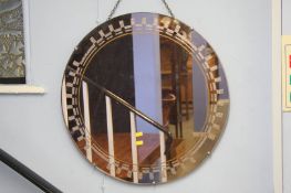 A copper coloured circular mirror