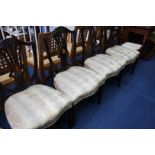 A set of four mahogany shield back dining chairs