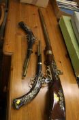 Three reproduction flintlock guns