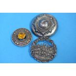 Three silver coloured brooches