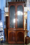 A tall mahogany bookcase two glazed doors, over tw