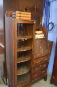 A carved oak bureau bookcase by 'The West End Furn