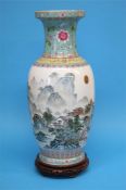 A large Chinese vase on stand decorated with lands