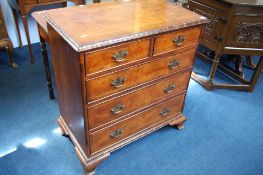 A Reproduction walnut straight front chest of draw