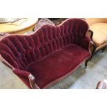A mahogany sofa with maroon upholstery