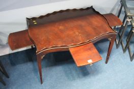 An Edwardian mahogany tray table with four pull ou