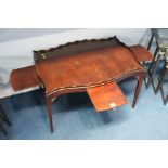 An Edwardian mahogany tray table with four pull ou