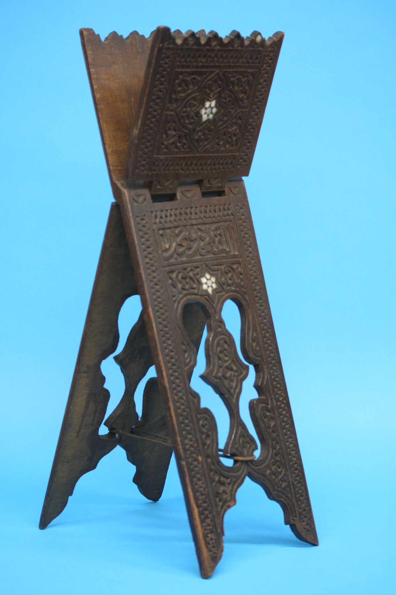 A Middle Eastern folding stand with pierced and ca