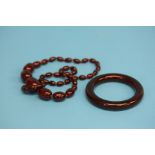 A red amber coloured necklace and a red amber colo