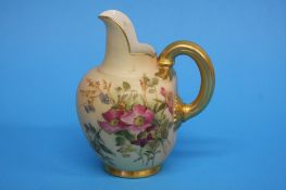 A Royal Worcester flat back jug decorated with flo