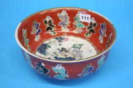 An Oriental bowl, the interior decorated with land