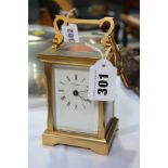 A carriage clock and key, signed Angelus