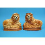 A pair of recumbent Staffordshire lions, 24cm heig