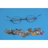 A silver charm bracelet and a pair of old spectacl