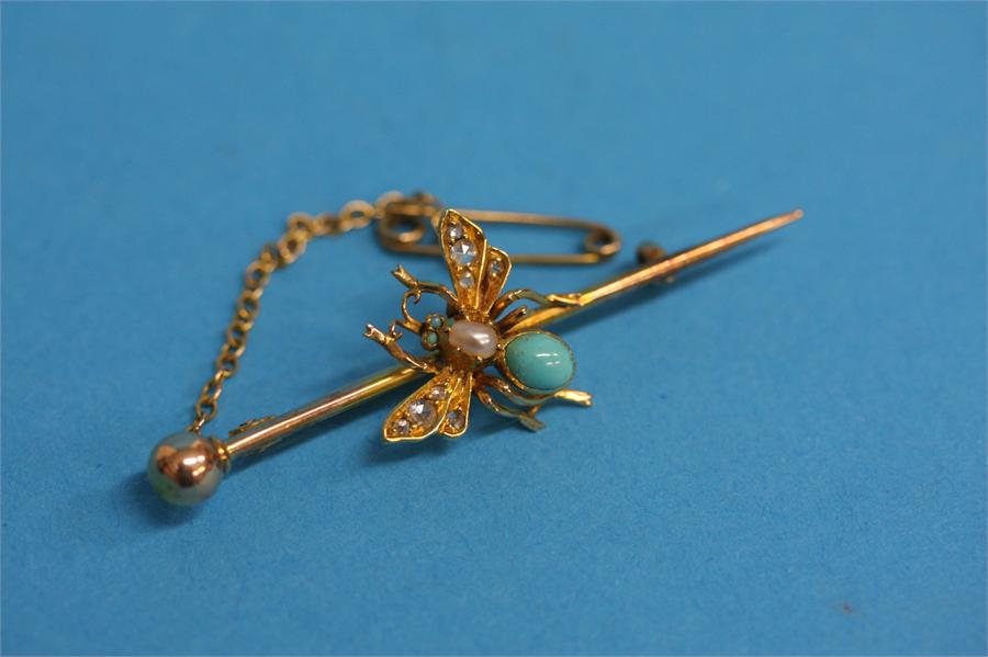 A gold bar brooch set with turquoise, pearl and di