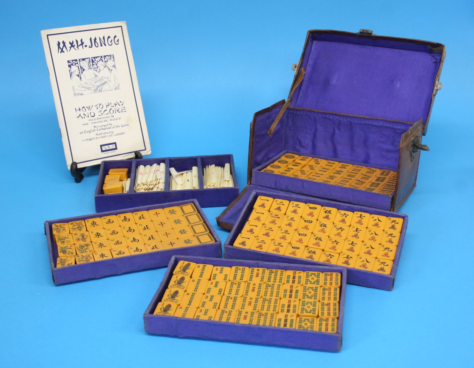 An embossed leather cased Mah Jong set. 21 x 13 x