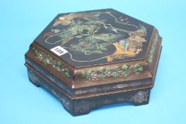 An Oriental papier mache box, opening to reveal a