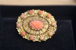 A yellow metal and coral brooch