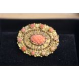 A yellow metal and coral brooch