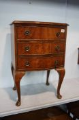 Serpentine walnut chest of drawers