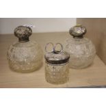 Three silver top bottles