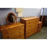 Two pine chest of drawers, bedside chest and a cheval mirror