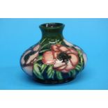 A modern squat shape Moorcroft vase on a green and