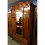 A late 19th century mahogany mirror door wardrobe