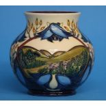 A modern Moorcroft vase of baluster form on a crea