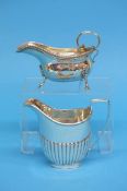 A silver semi-fluted cream jug and a silver sauceboat, weight 9.2oz/286.5gm