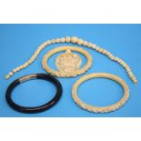 Two Ivory carved bangles, a necklace, pendant etc.