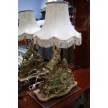 A brass mantle clock and lamp on marble base