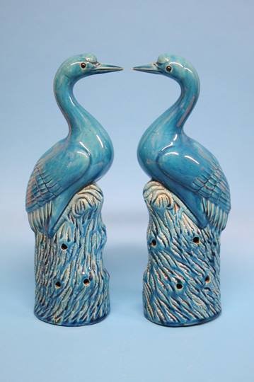 A pair of Continental tin glaze models of storks w