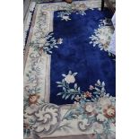 A large Chinese design carpet on blue ground