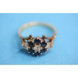 An 18ct gold diamond three stone ring set with six sapphires