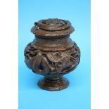 An Oriental carved wood vase and cover, decorated