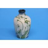 A modern Moorcroft vase on a cream ground decorate