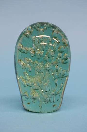 A Victorian green glass dump filled with air bubbl