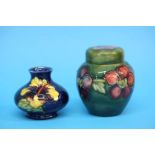 A small Moorcroft ginger jar on a green ground and