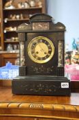 A black marble mantle clock