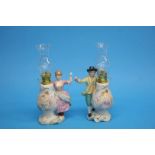 A pair of Continental porcelain figural oil lamps 25cm height