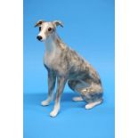 A Winstanley seated lurcher. 32cm height
