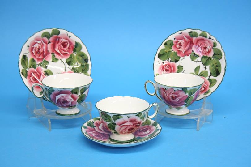 A set of three Wemys cups and saucers decorated wi