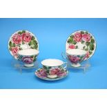 A set of three Wemys cups and saucers decorated wi